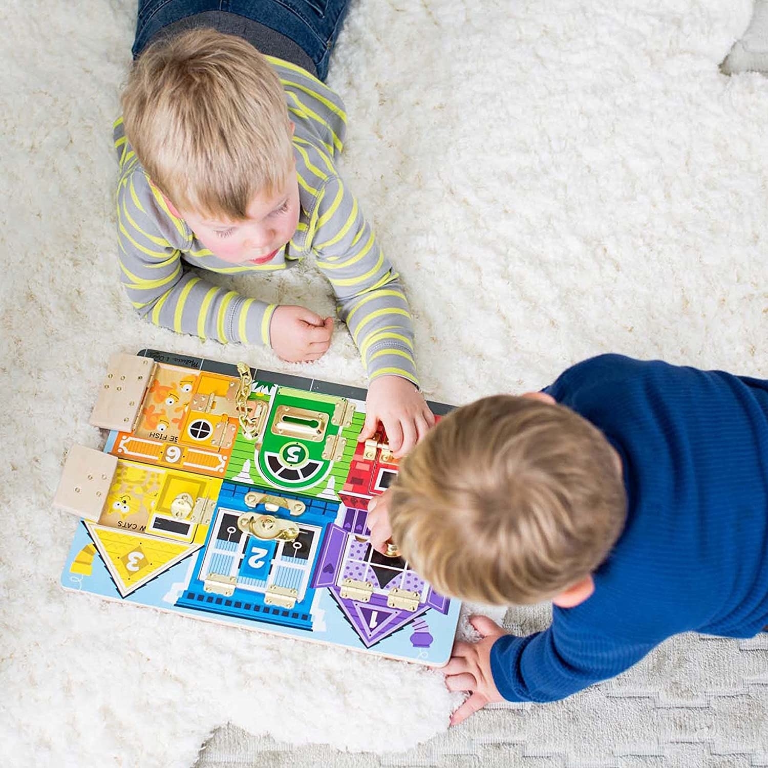 Two kids playing with the board on a carpet