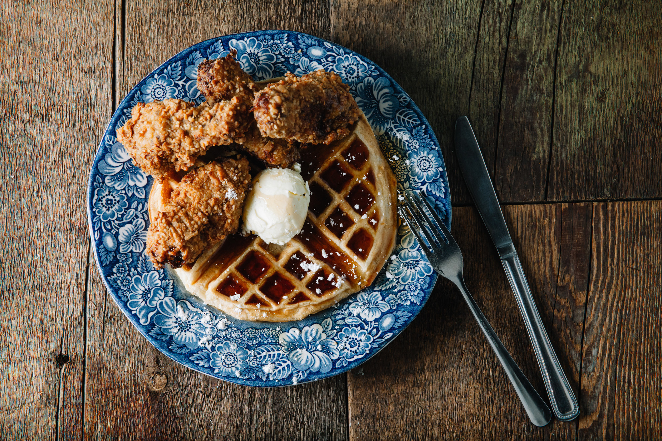 Chicken wings and waffles served with butter