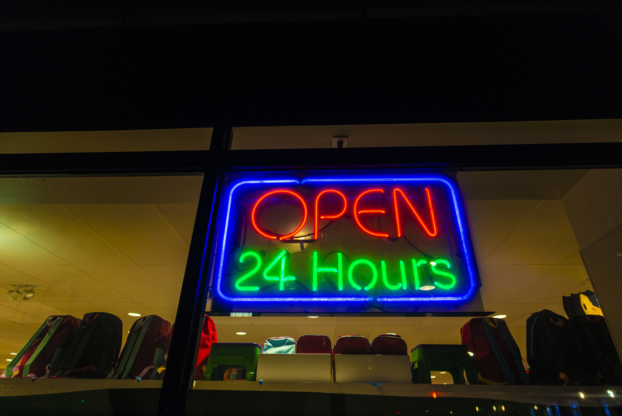 Neon &quot;Open 24 hours&quot; sign at night