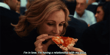 Julia Roberts eats a piece of pizza while saying &quot;I&#x27;m in love. I&#x27;m having a relationship with my pizza.&quot;