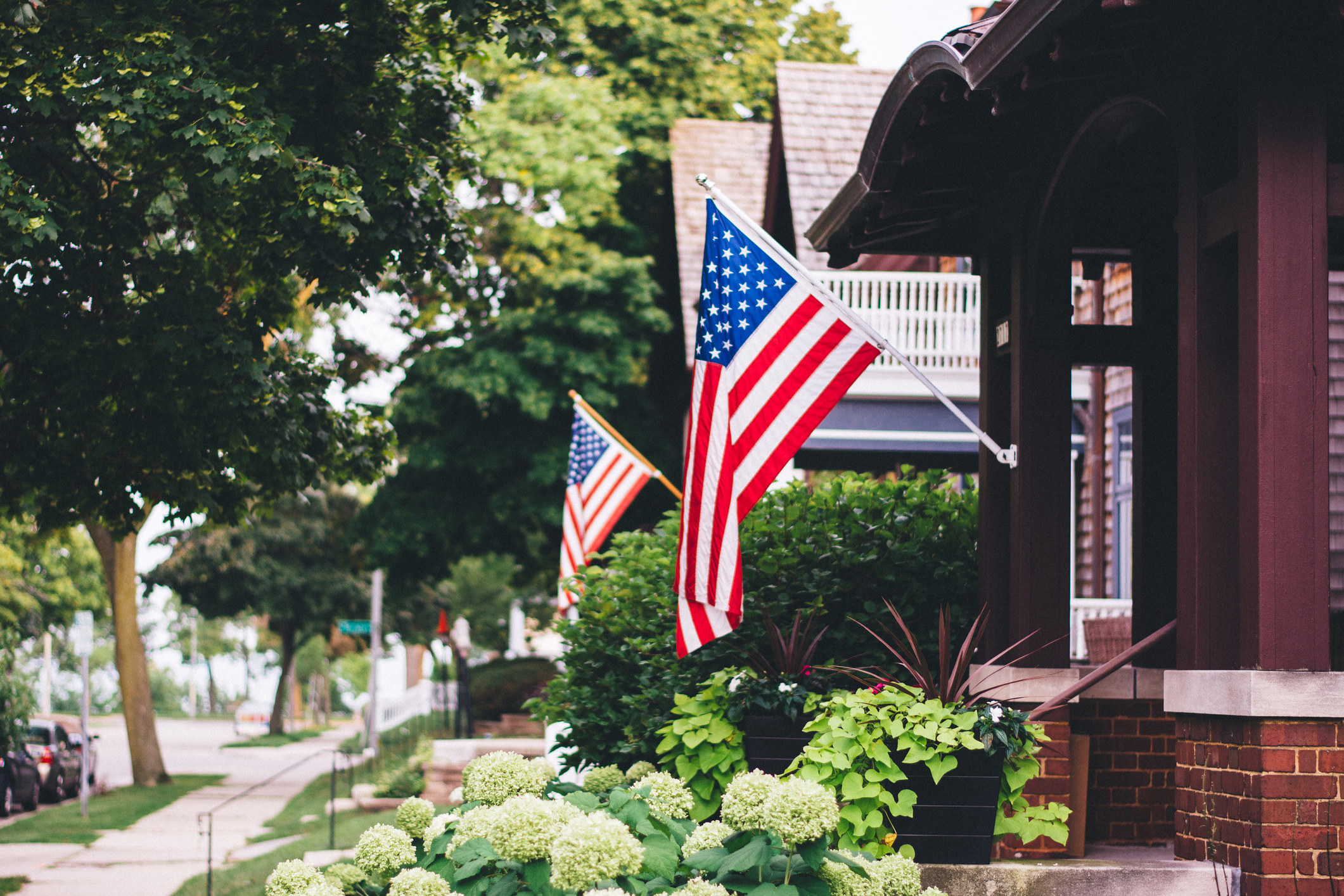 Houses with American flags hanging outside