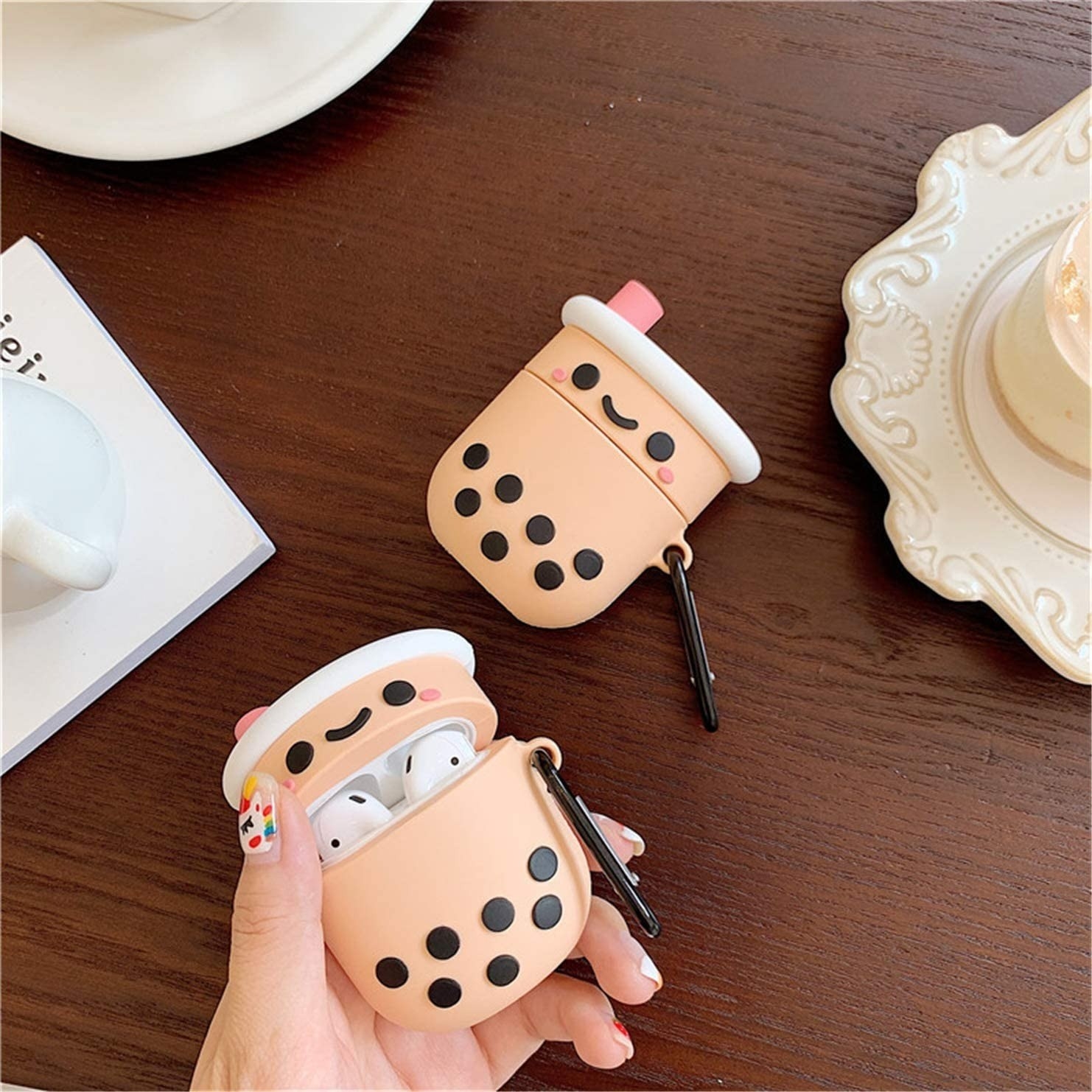 hand holding boba tea-shaped cute AirPods case