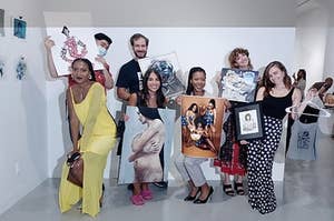 Group of artists posing for a photo during an exhibition