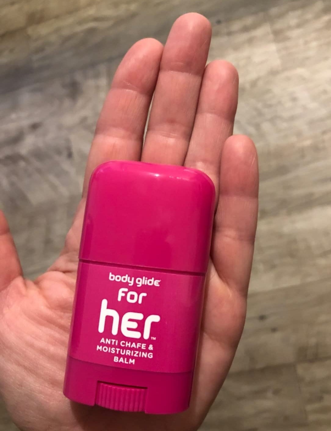 a reviewer holding the pink balm