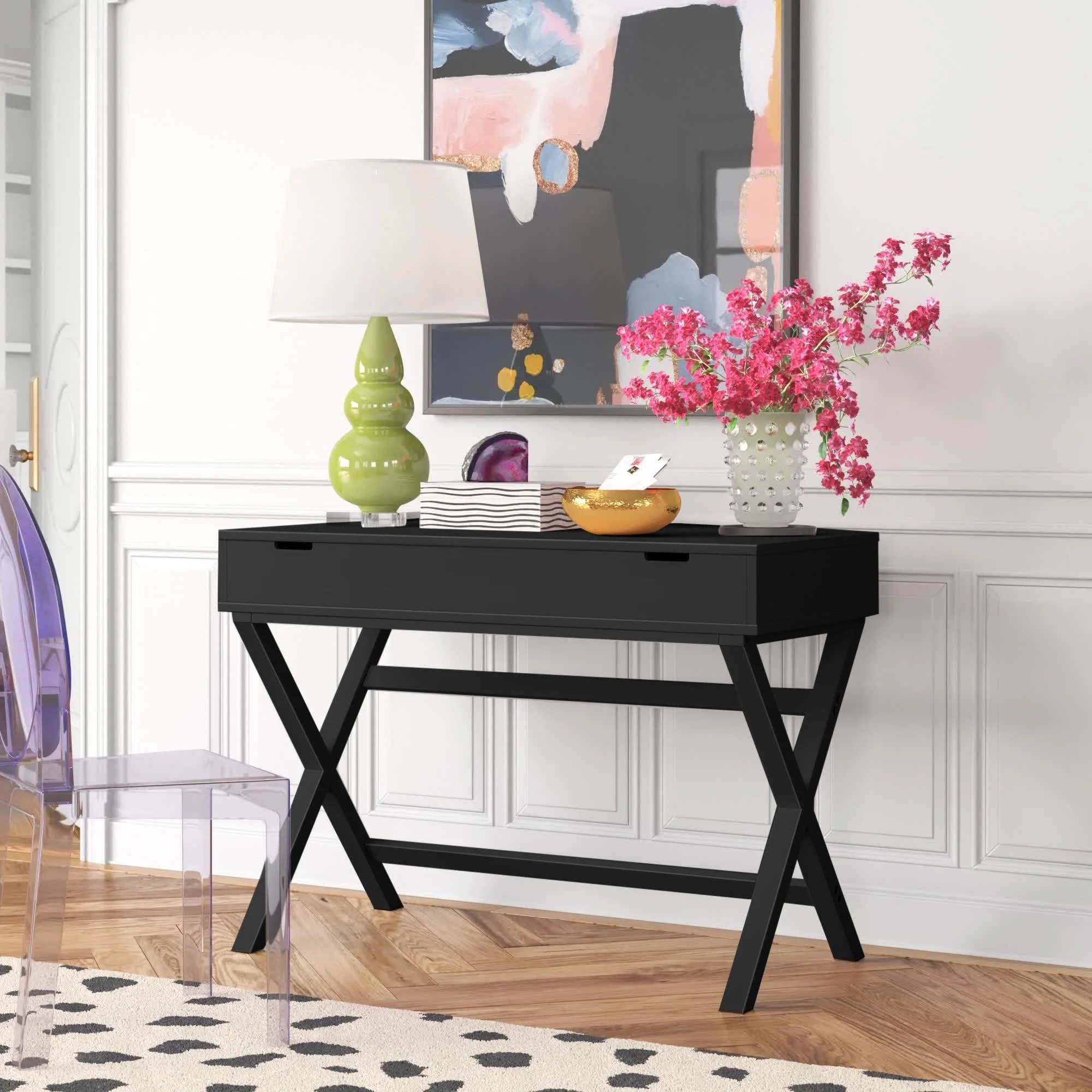 a black adjustable desk against a wall