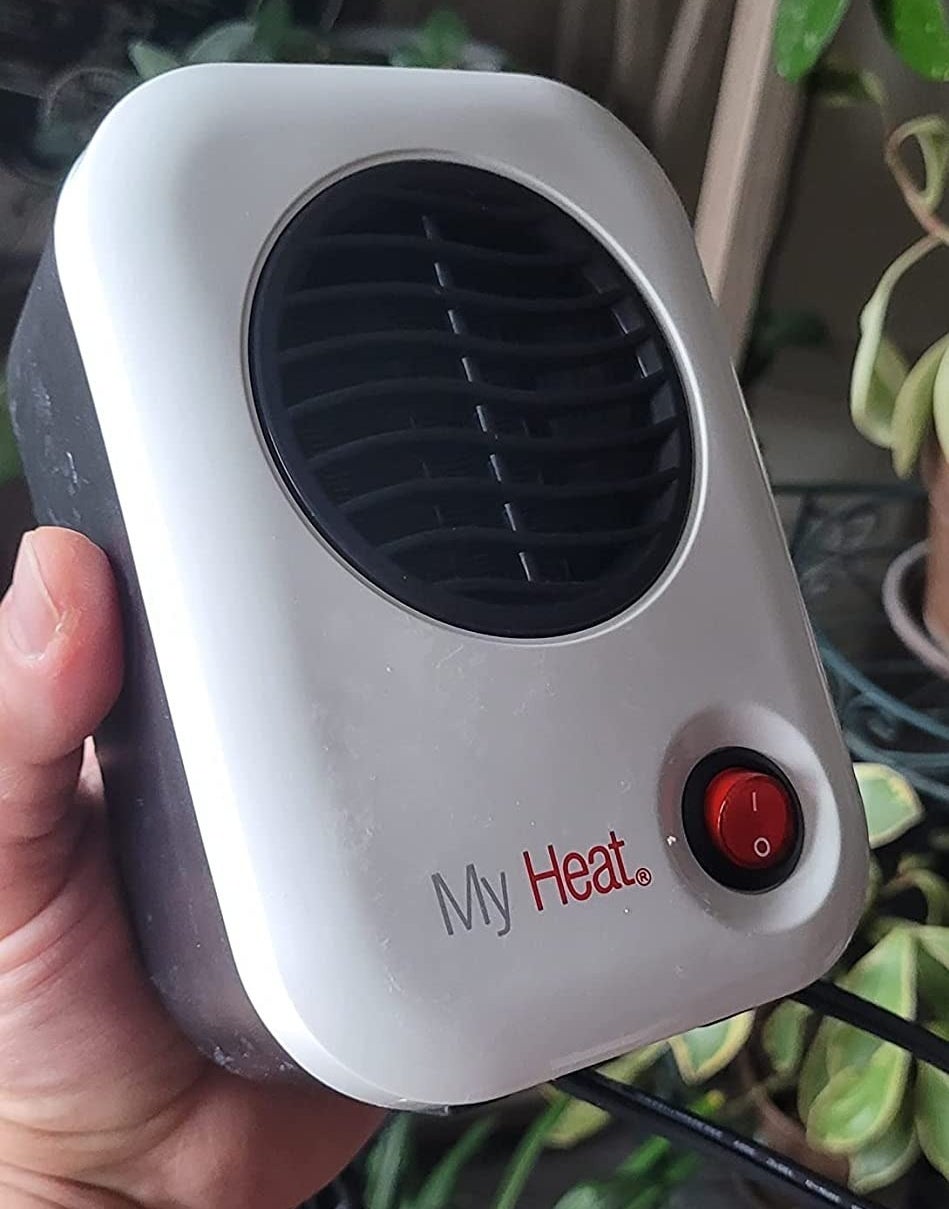 a reviewer photo of a hand holding the small heater