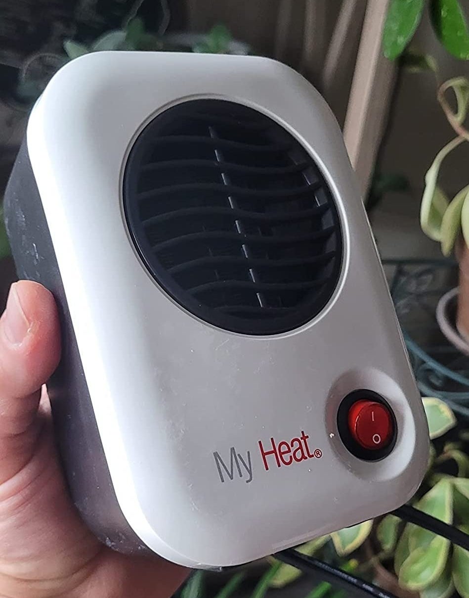 a reviewer photo of a hand holding the small heater