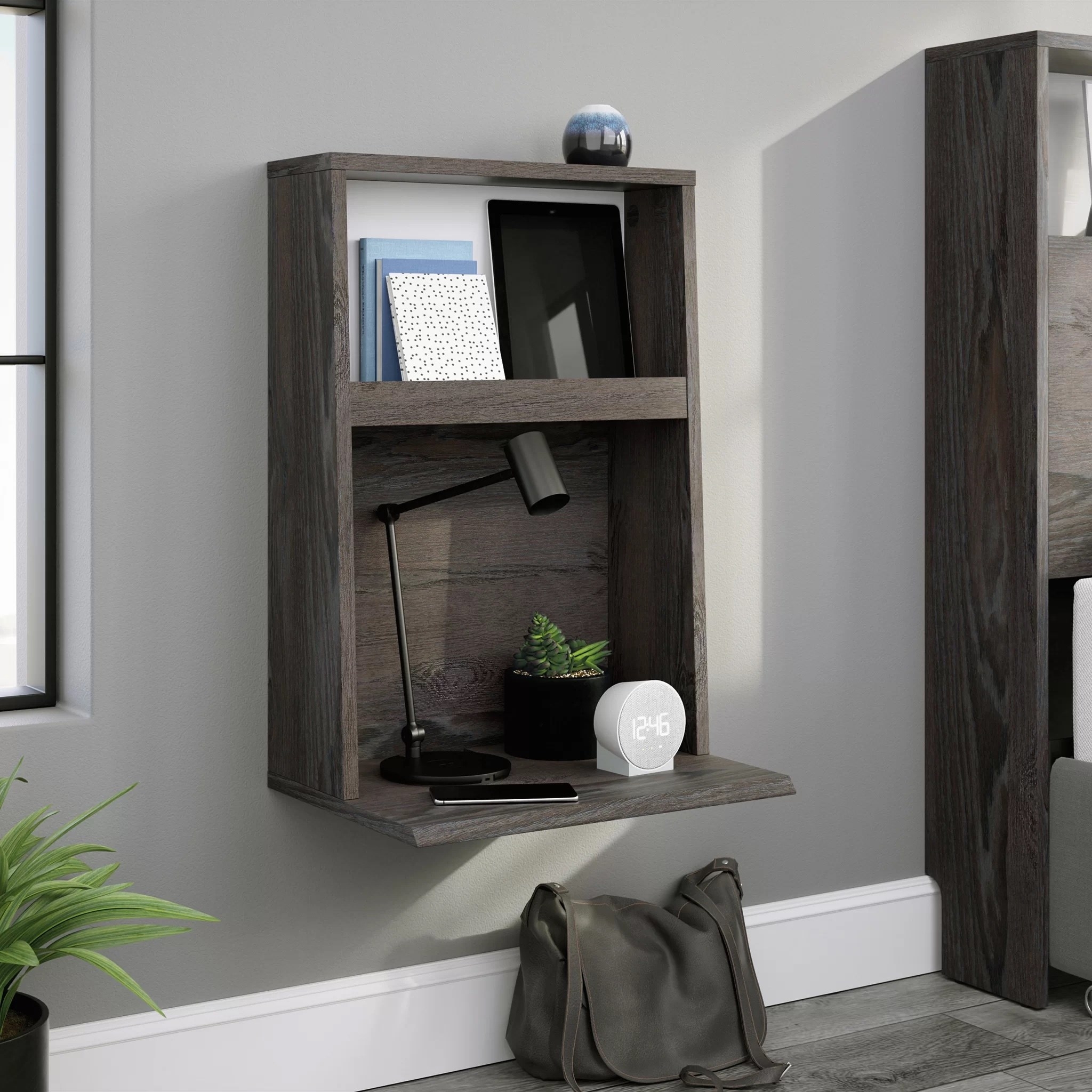 a charcoal floating nightstand in a beddroom