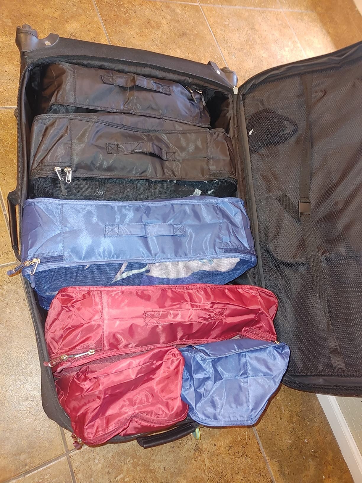 a reviewer photo of the cubes packed into a suitcase