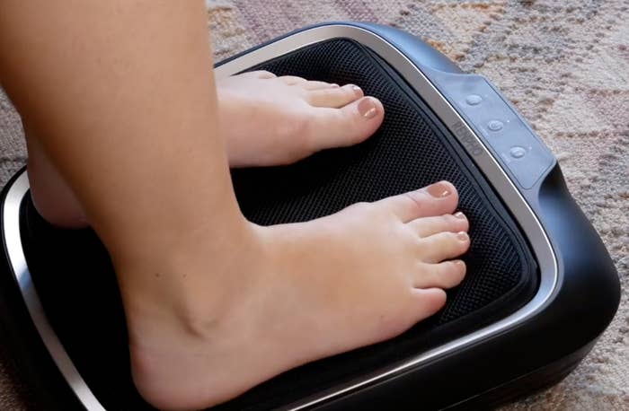 person with their feet on the massager