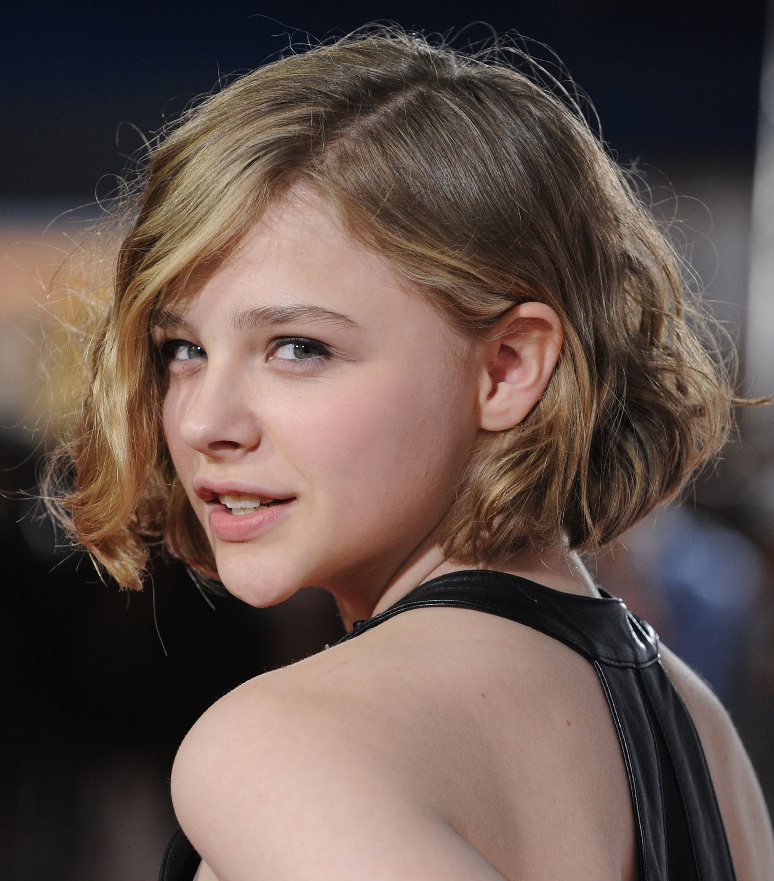 The kid behind Chloe Grace Moretz looks like a man in his 30's : r/funny