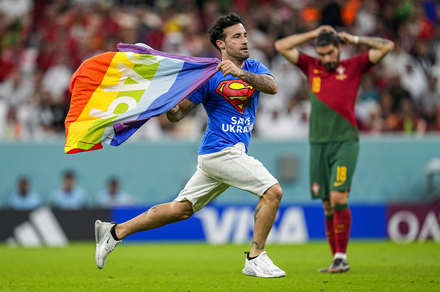 A Protester Holding A Rainbow Flag And Wearing A T-Shirt That Said "Save Ukraine" And "Respect For Iranian Women" Ran Onto The Field During A World Cup Match