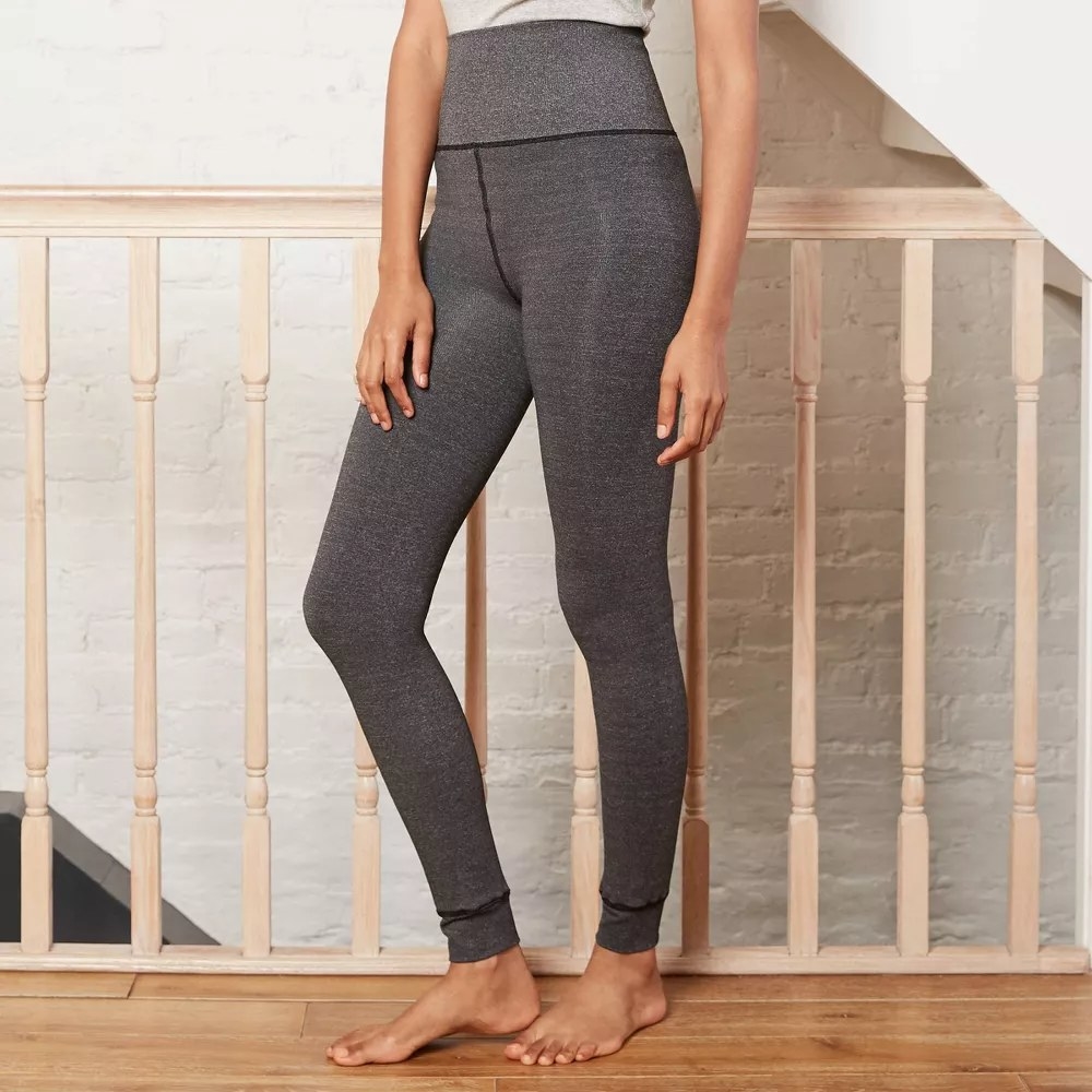 a model wearing the leggings in the color Charcoal
