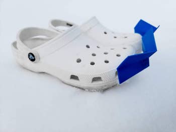 white crocs with blue snow plow attachments