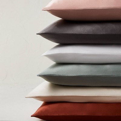A pink, black, grey, blue, cream and red pillowcase