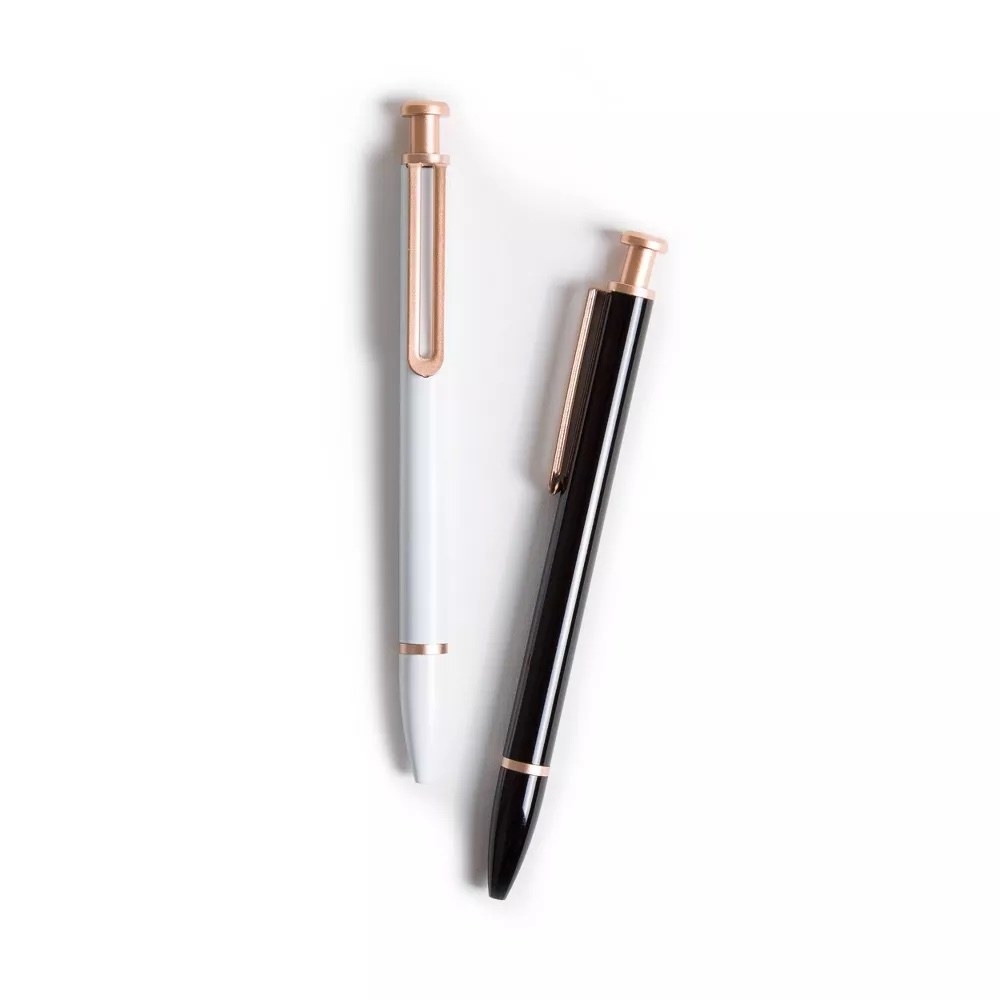 A white and rose gold pen and a black and rose gold pen