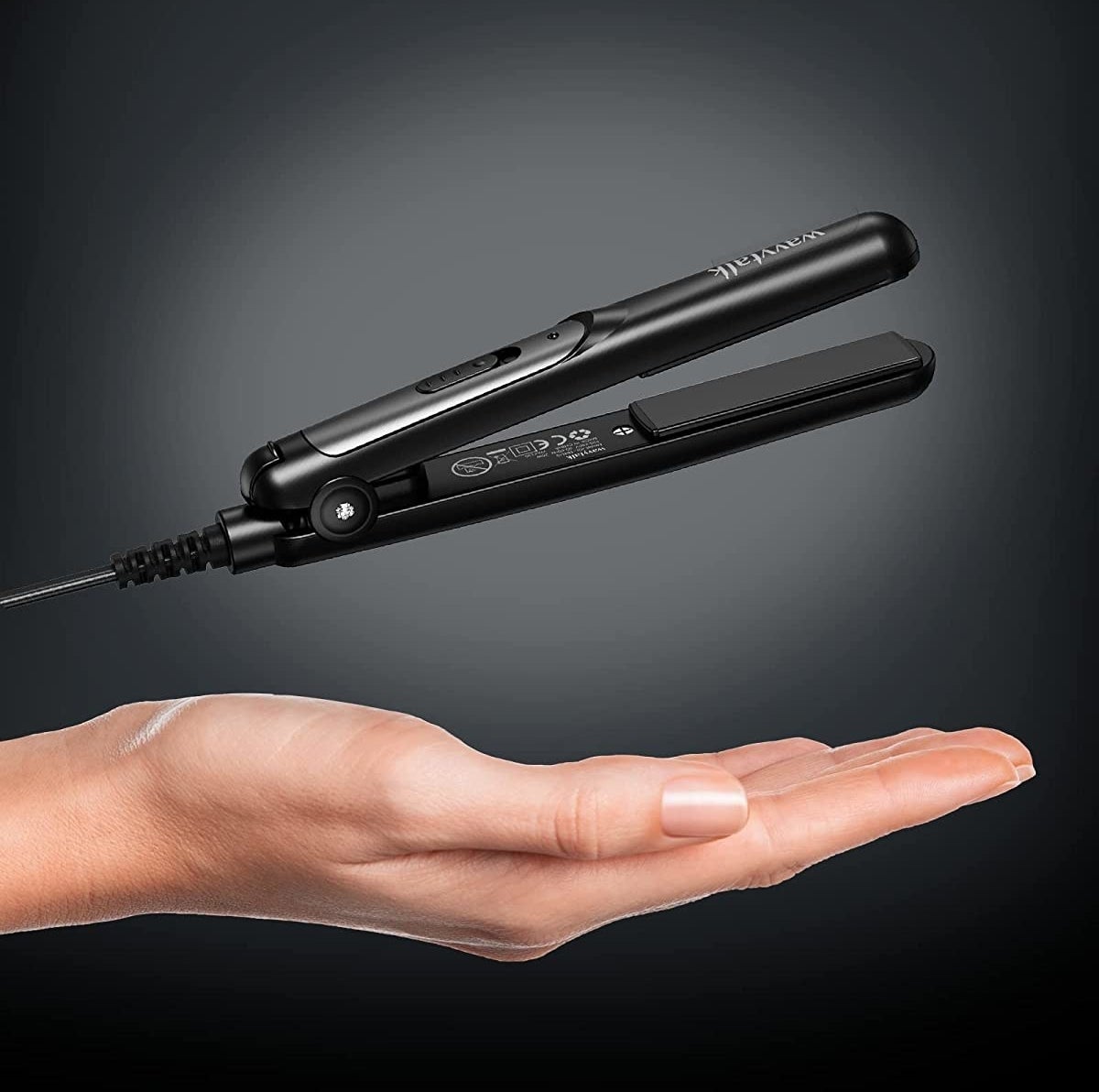 the flat iron above someone's hand