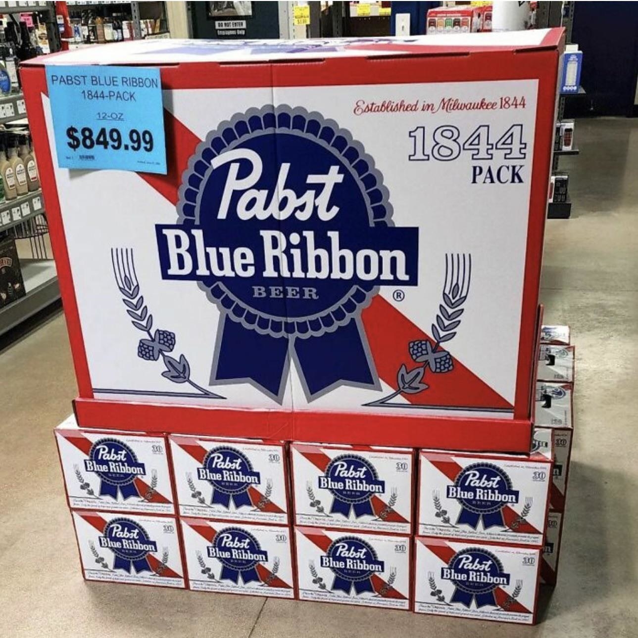 An enormous pack of Pabst Blue Ribbon, selling for $849, on top of much smaller containers in a store display
