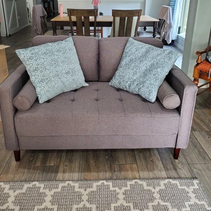 a reviewer photo of the gray loveseat
