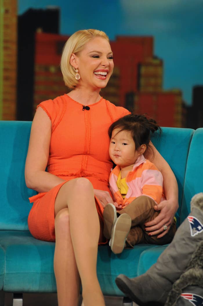 A young Naleigh sits on a couch with Katherine