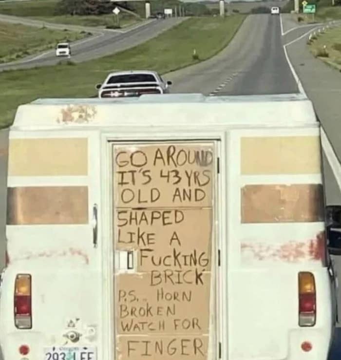 Sign on old truck says, Go around, it&#x27;s 43 years old and shaped like a brick. PS, horn broken, watch for finger