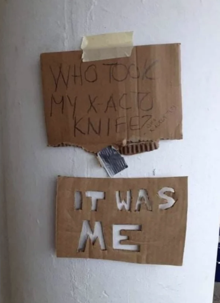A sign says, Who took my x-acto knife? The second sign with letters carved using an x-acto knife says, It was me