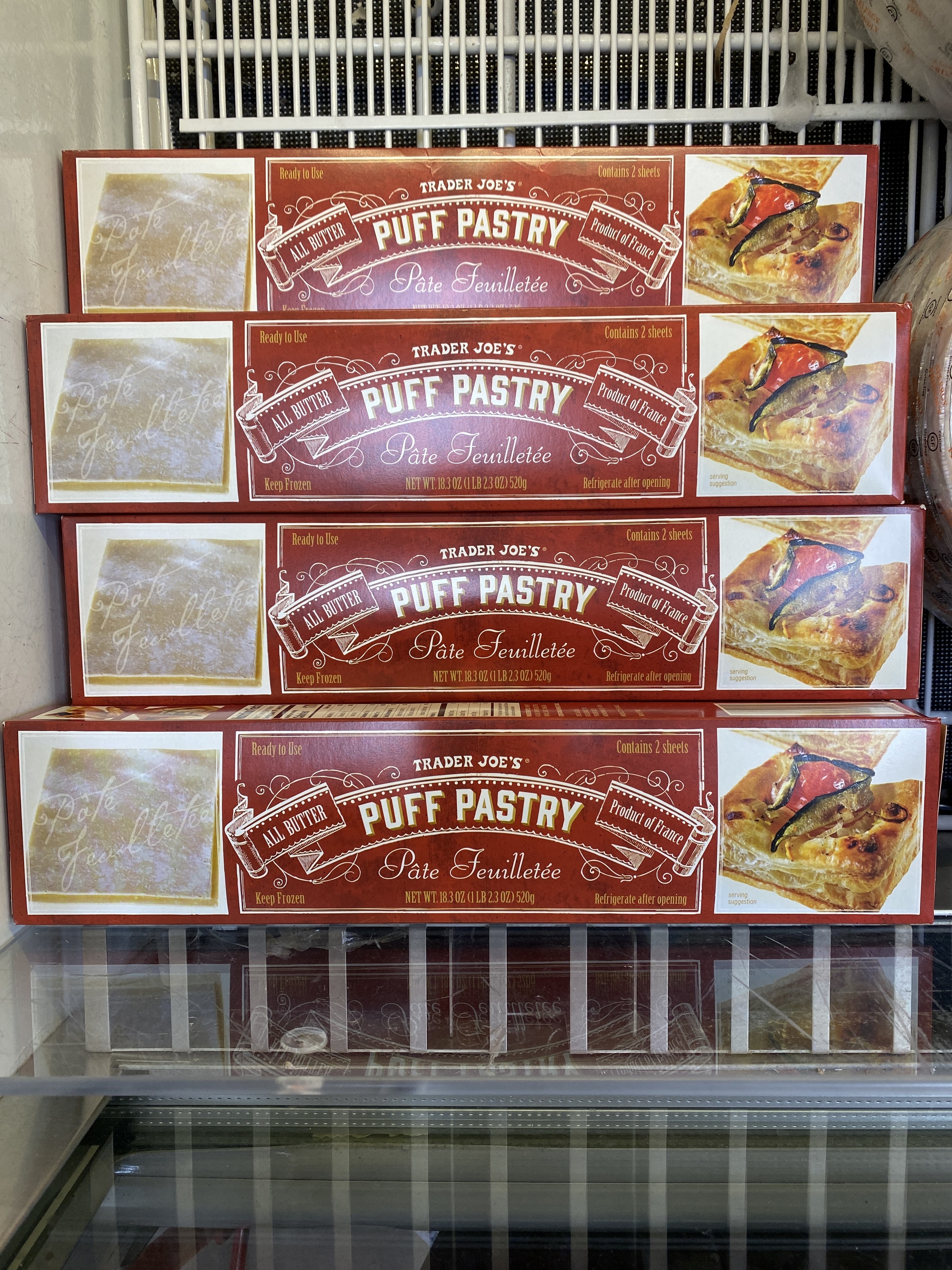 four boxes of puff pastry in freezer case