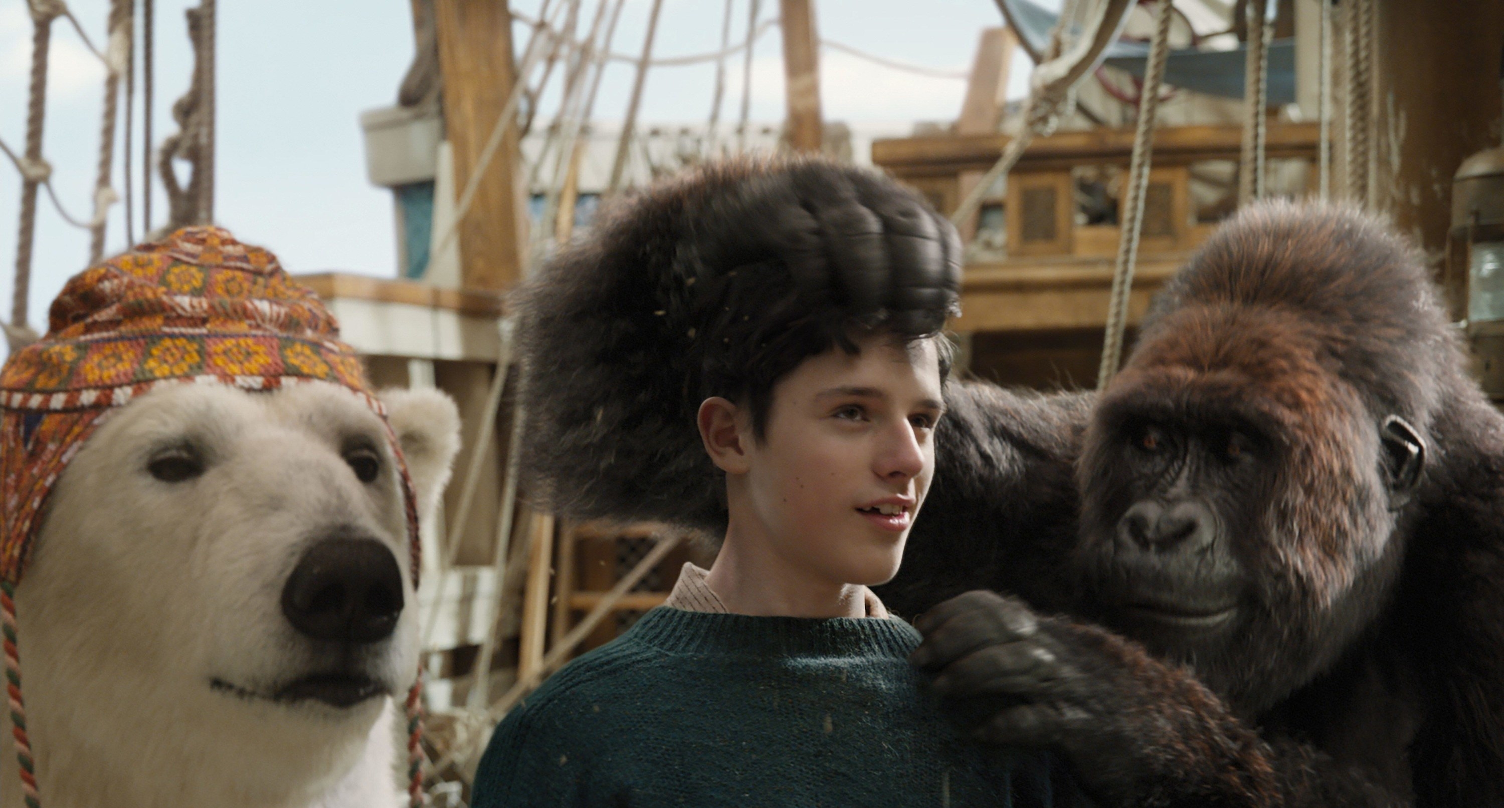 A young boy is comforted on a galleon by a gorilla and a polar bear in a hat