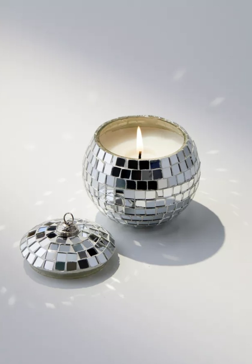 The disco ball candle has little flecks of light reflecting and is filled with white wax and a small flame