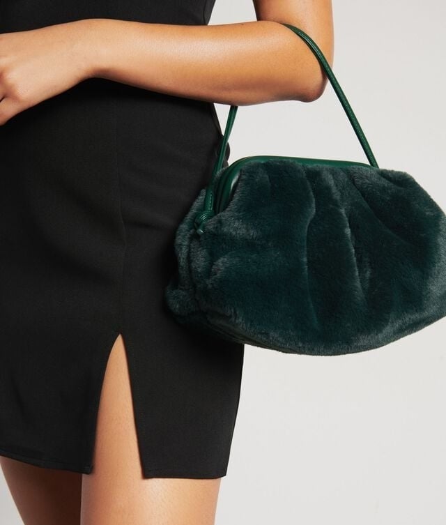 a close up of the furry purse around the model&#x27;s arm
