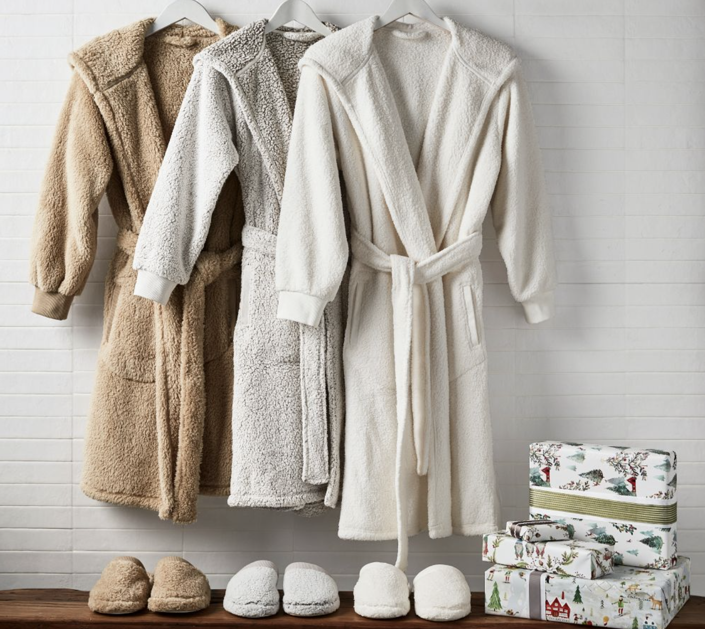 three different sherpa robes in different neutral colors