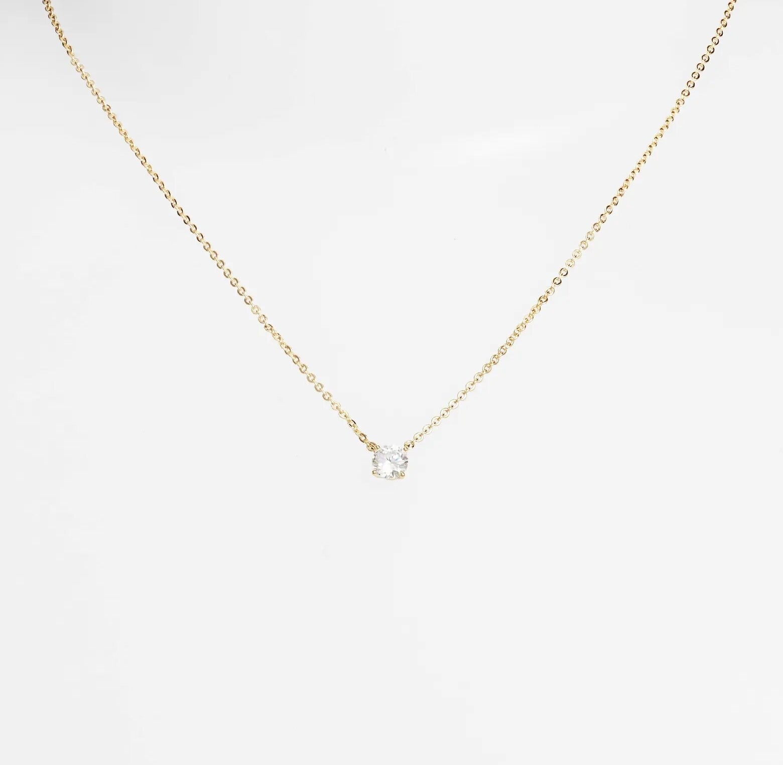 the necklace hanging off a mannequin-style neck