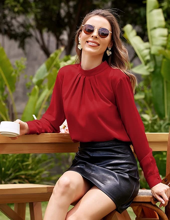 person wearing the blouse with a leather mini skirt