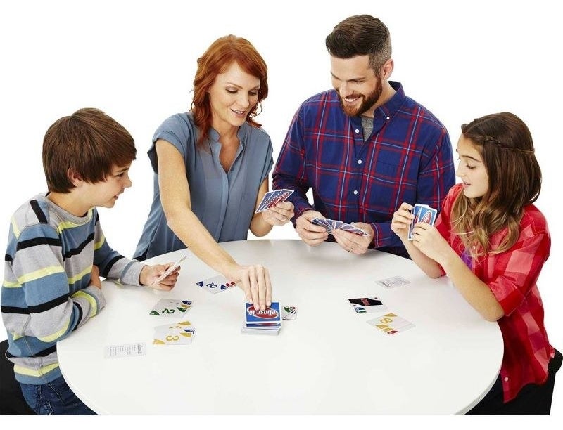 a group of models playing with the blue numbered cards