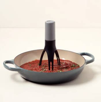 The pan stirrer in a pan filled with sauce