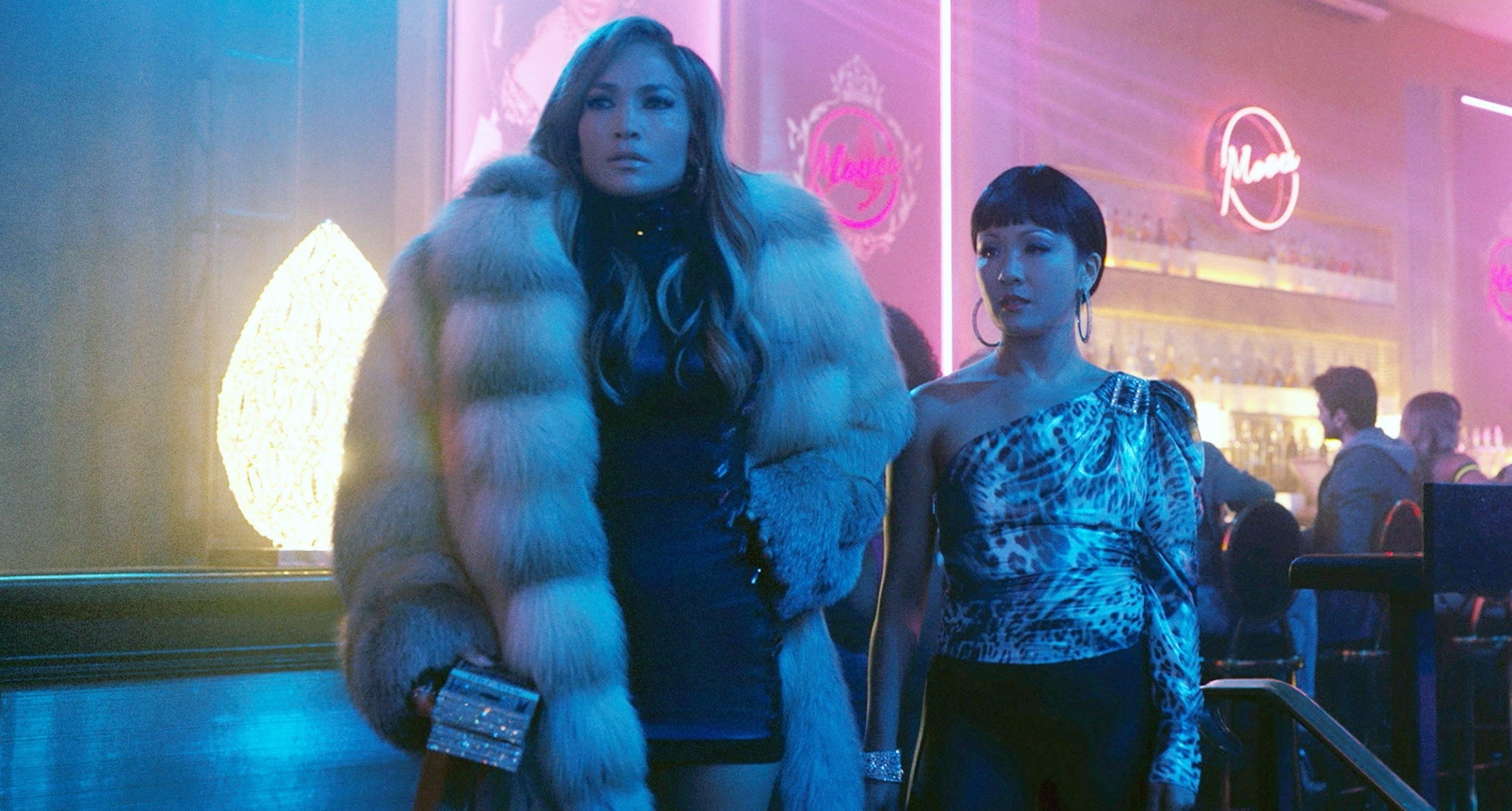JLo in a fur with Constance Wu in a club
