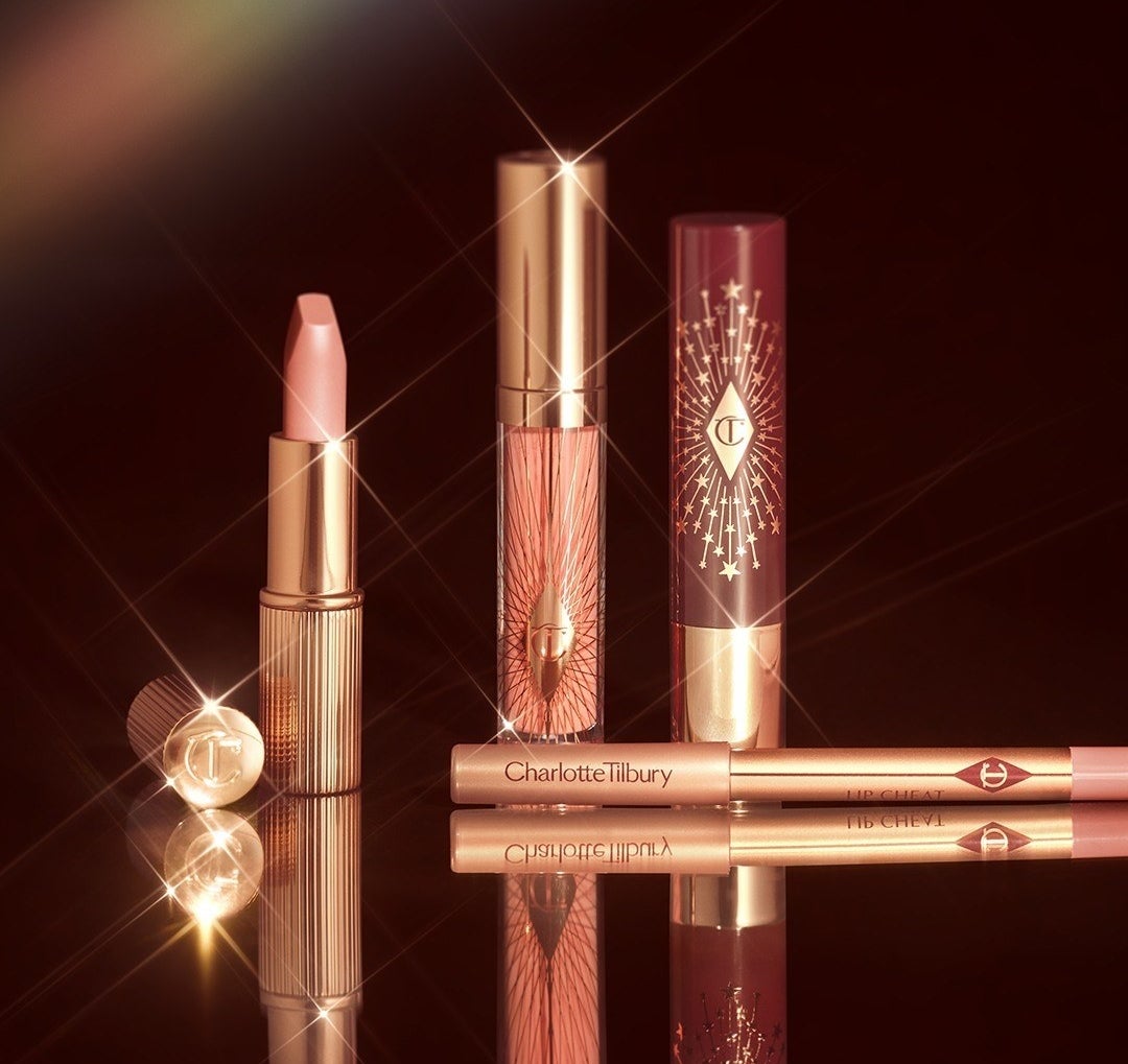 the four lip products glistening on a mirrored surface
