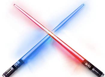 Two sets of glowing lightsaber chopsticks in blue and red