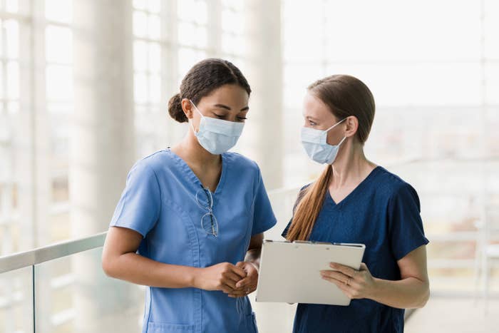 nurses talking to each other in a hospital