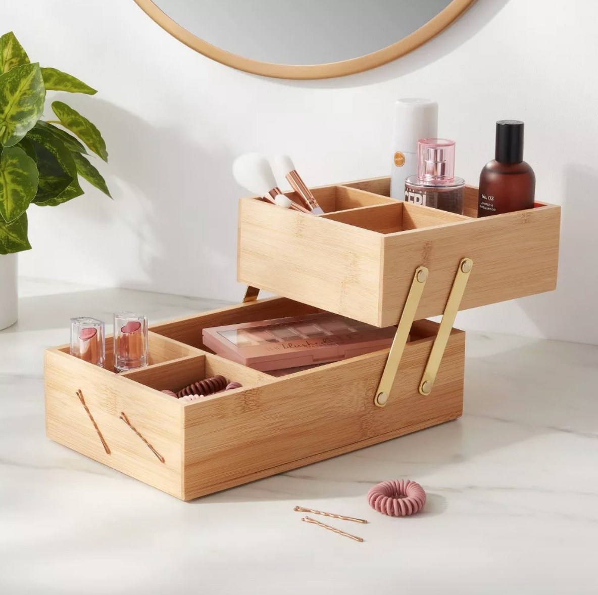 Two level wooden vanity organizer with makeup products inside