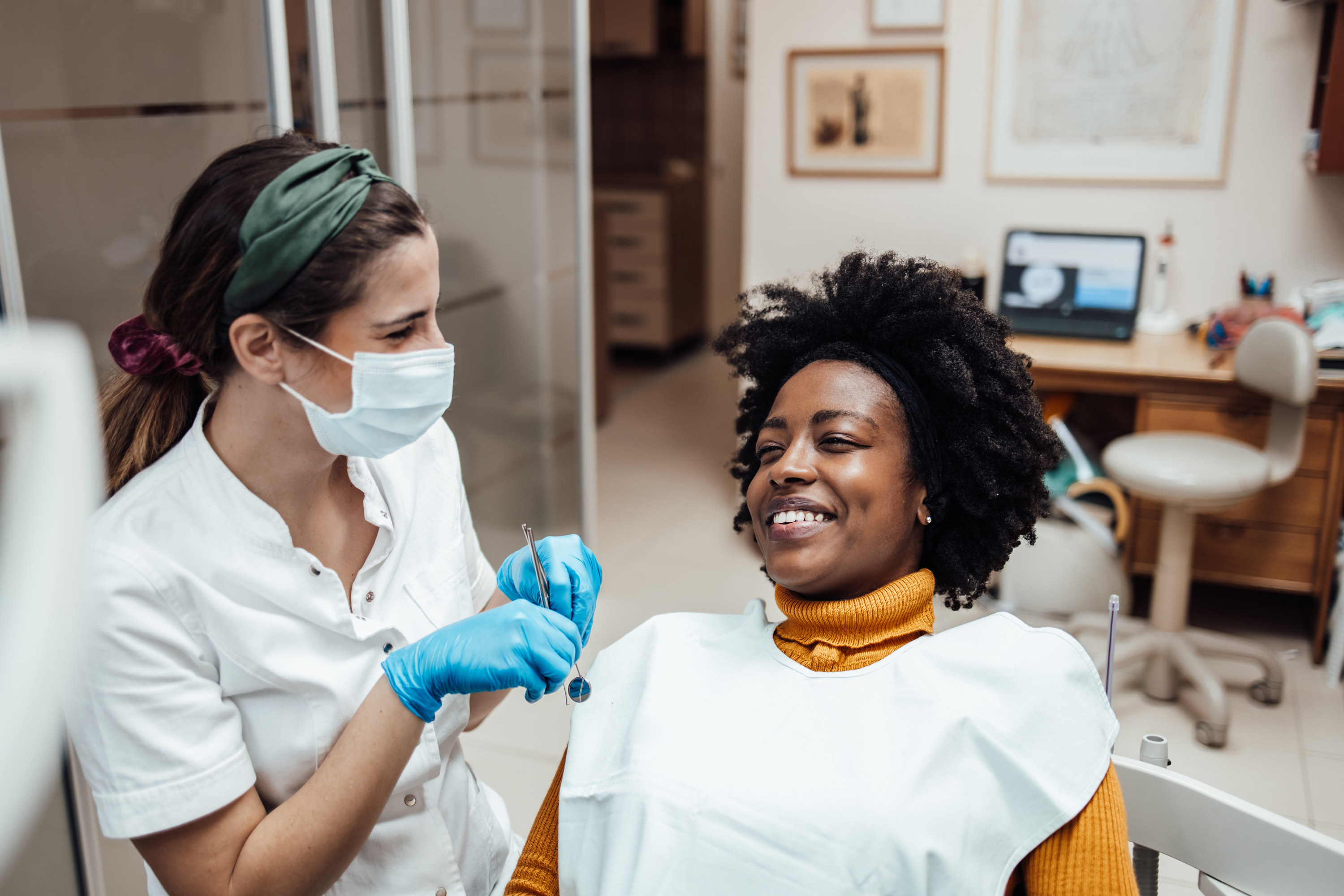 a patient in a chair with a dental assistant