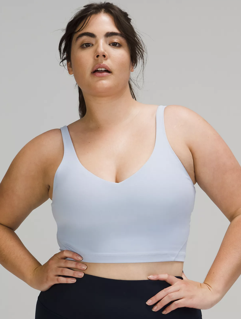 a model wearing the top in front of a background