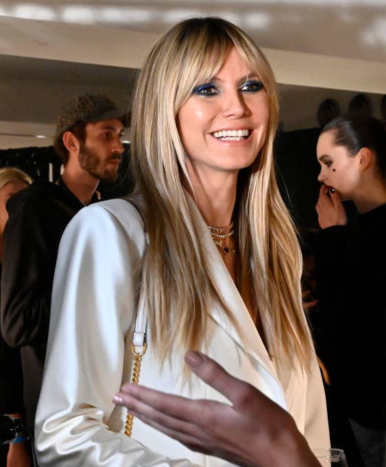 Heidi smiling and wearing a satiny jacket