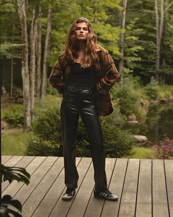 a person wearing the faux leather pants with an oversized shacket