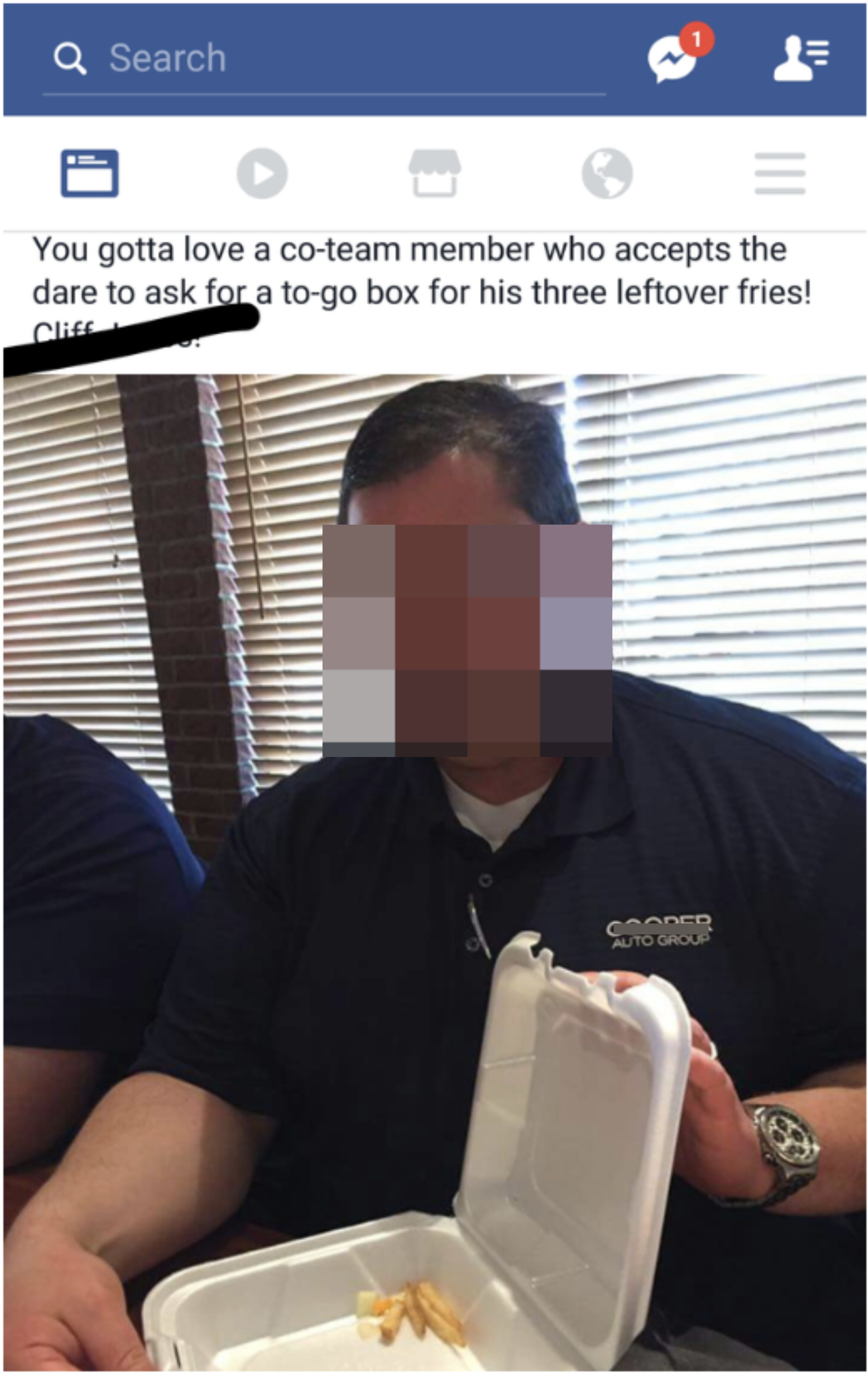 person opening up a to-go box to show three fries inside