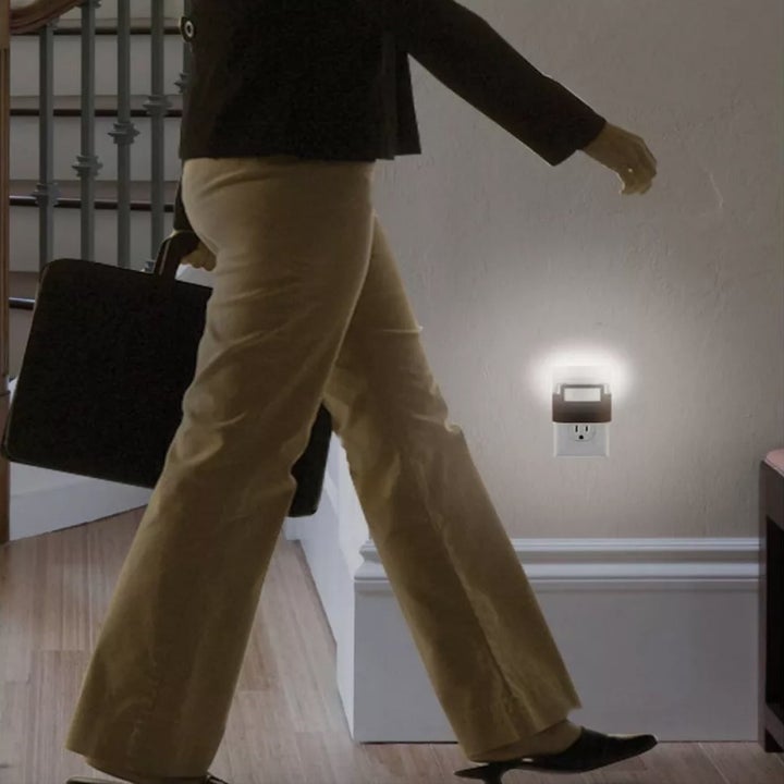 Model walking past motion activated nightlight in hallway