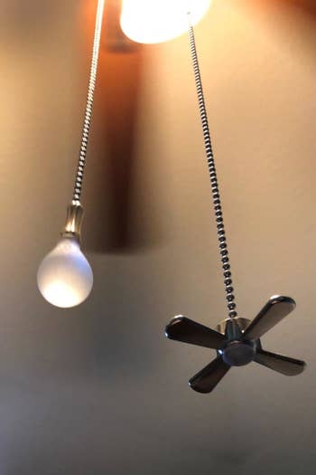 closeup of the fan and light bulb charms