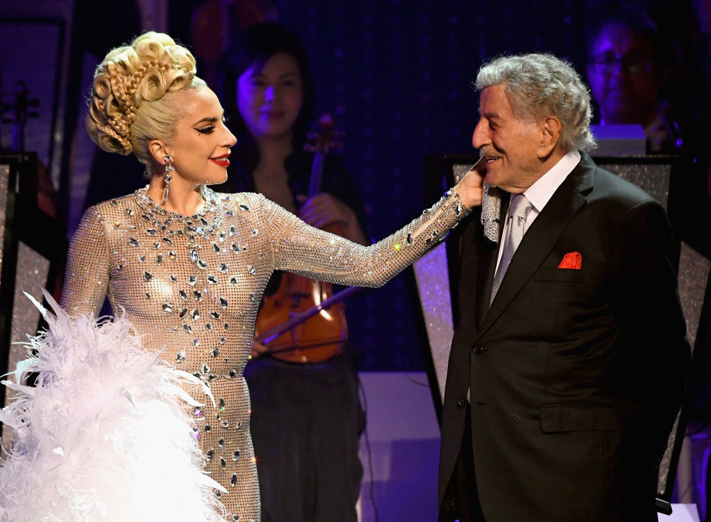Lady Gaga and Tony Bennet smile at each other on stage