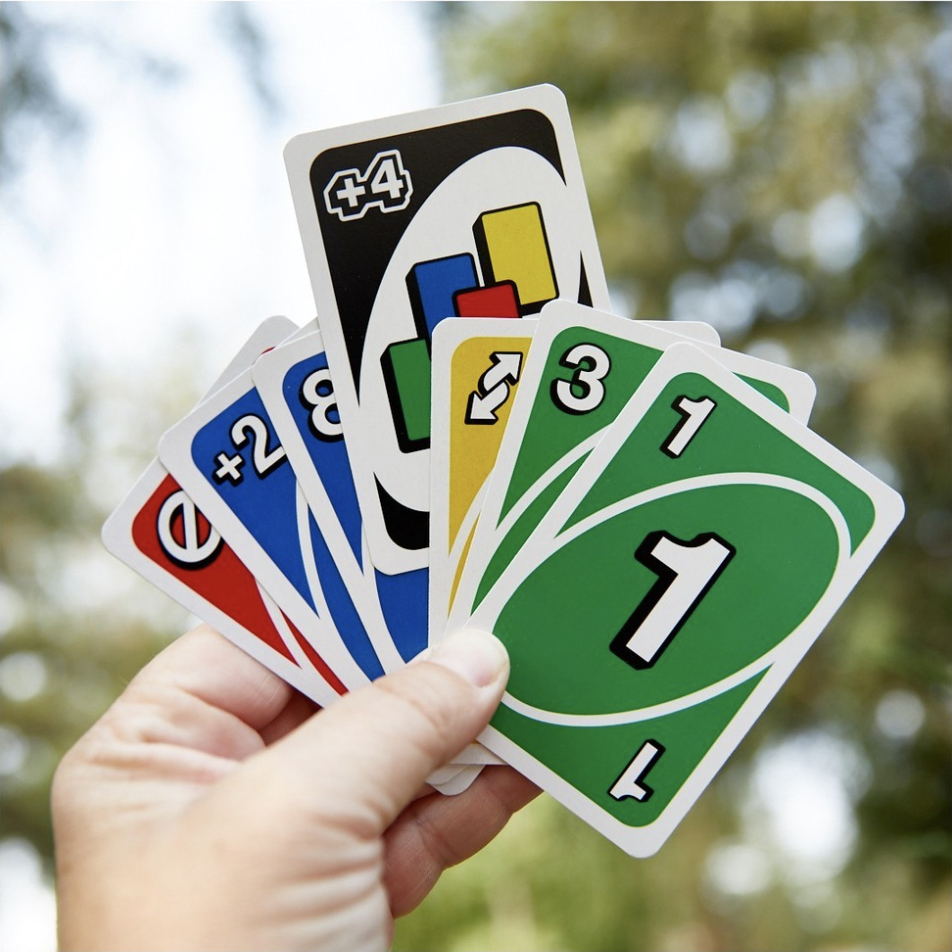 a person holding up a bunch of Uno cards