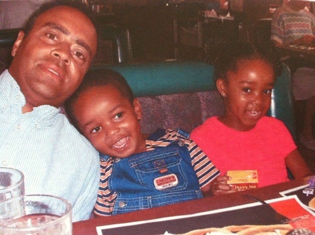 Uncle Blakey, Gabrielle&#x27;s brother, and Gabrielle sitting in a booth at a restaurant. Her brother has his head rested on Uncle Blakey&#x27;s shoulder.